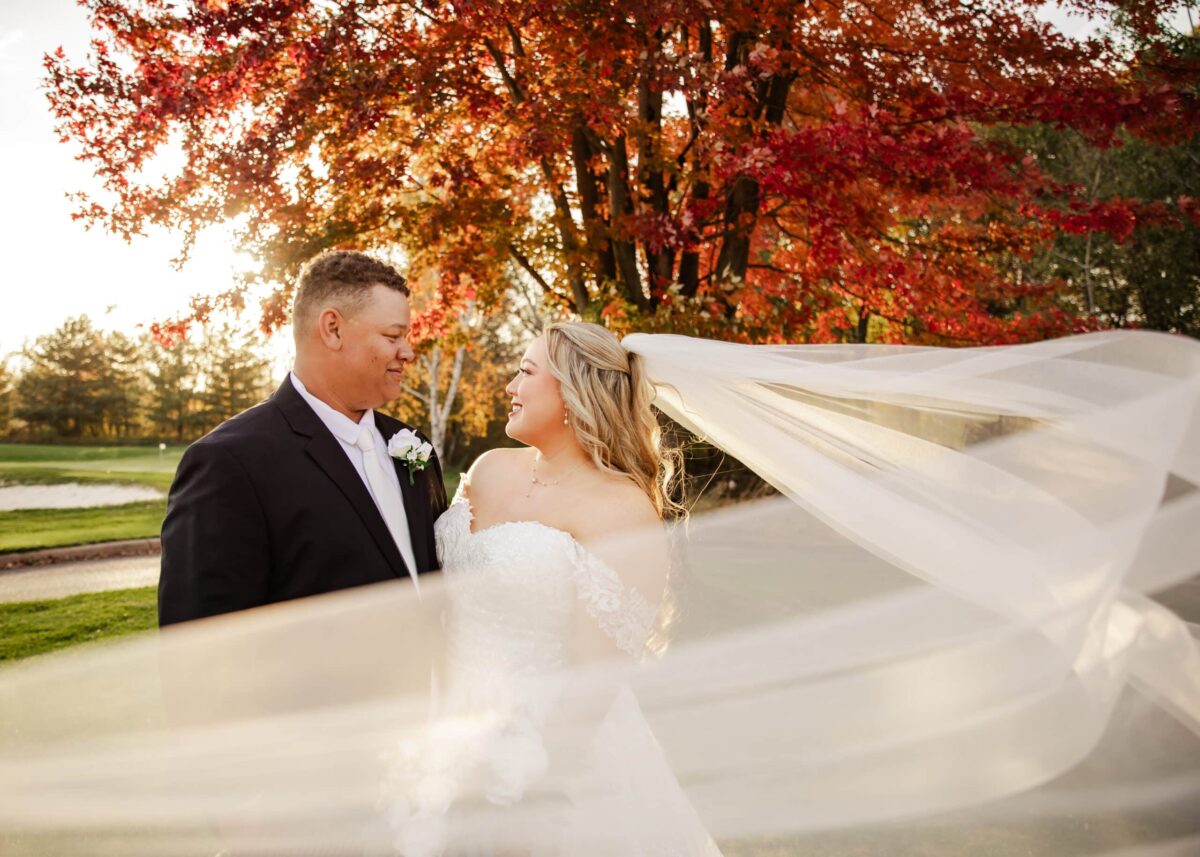 wedding couple side by side with sweeping veil GraceLyn Lee