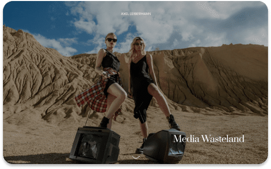 Two women in stylish outfits stand on vintage TVs in a desert landscape. Media Wasteland is overlaid
